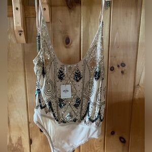 Free People Intimate Women’s beaded bodysuit.